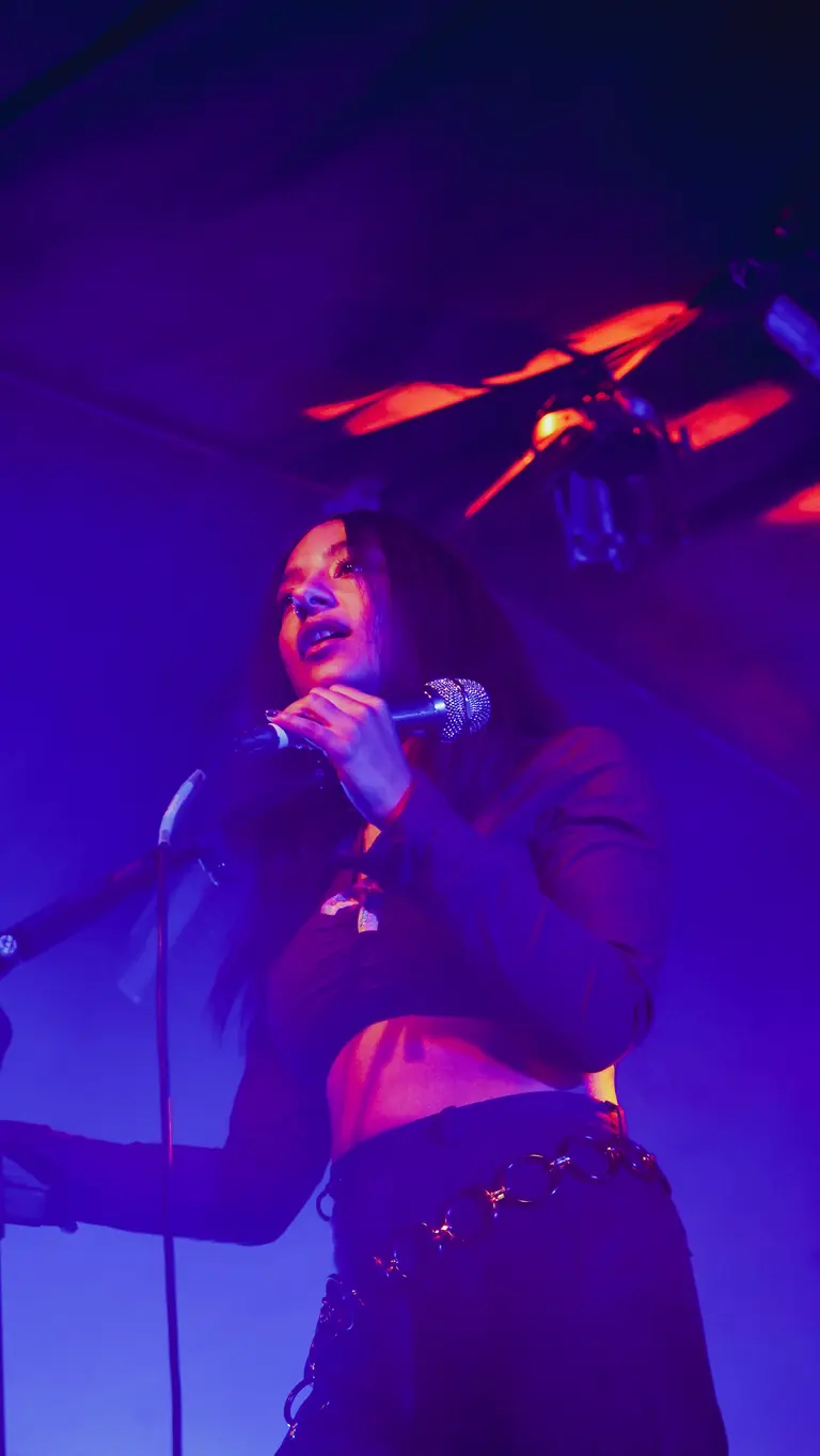 lily fontaine sings into a mic