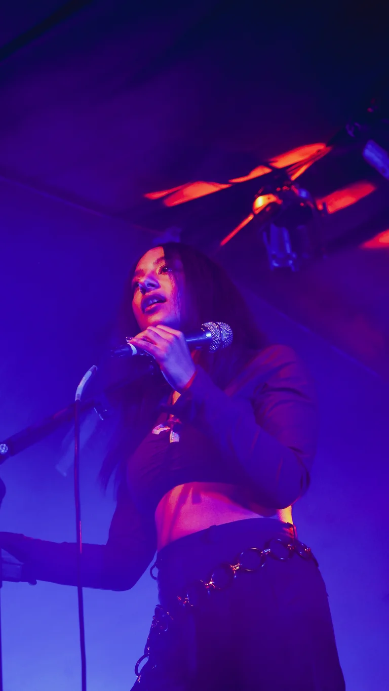 lily fontaine sings into a mic