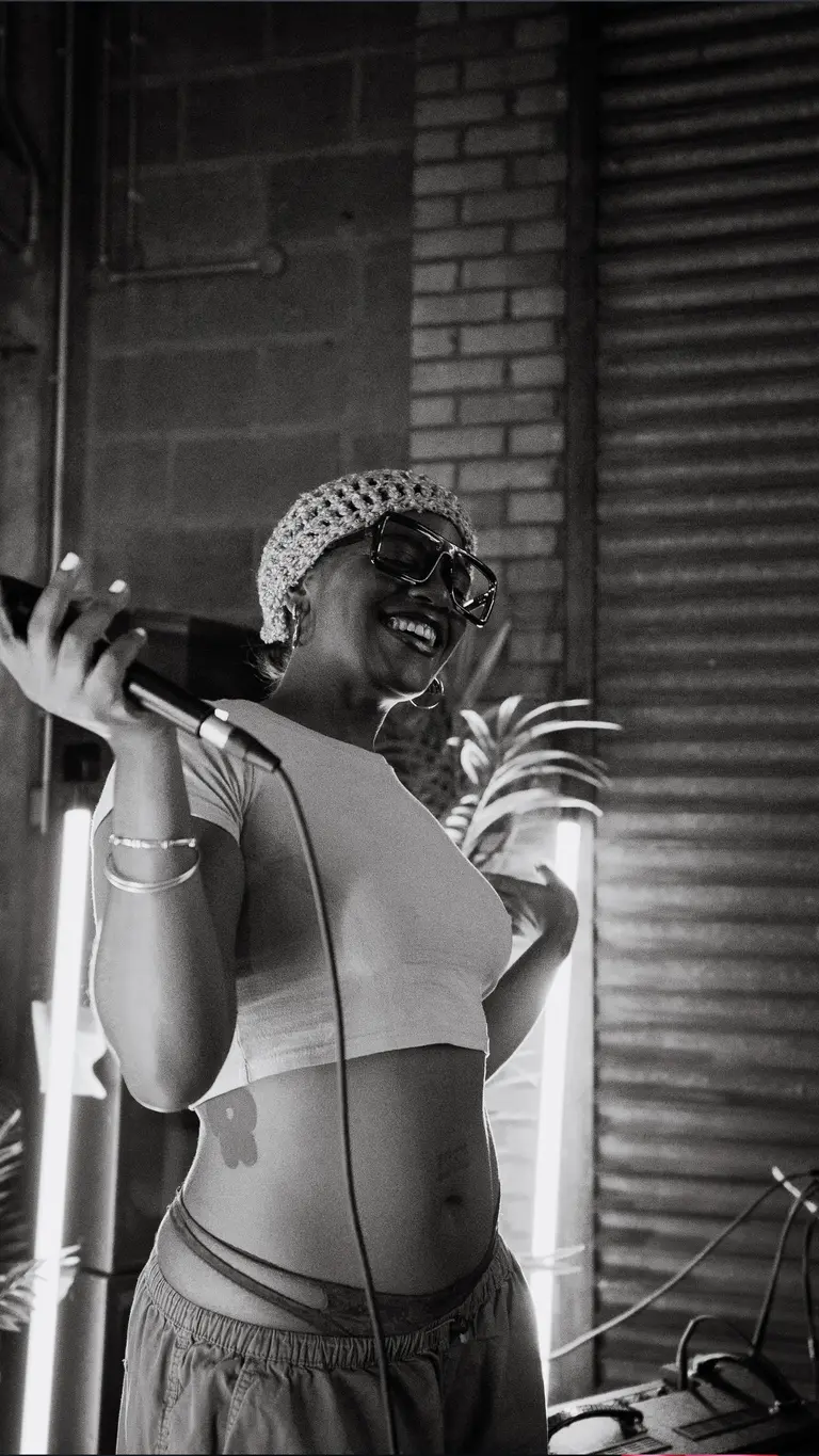 a musician dances with a mic in her hand