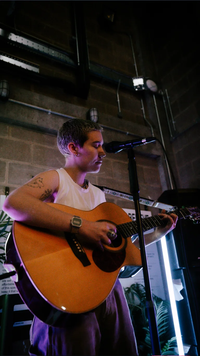 a musician holds a guitar and performs 