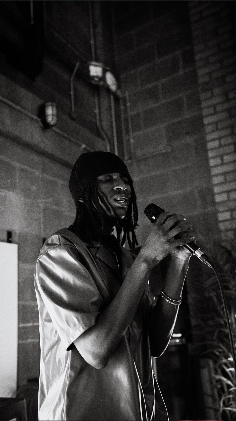 a musician performs into a mic