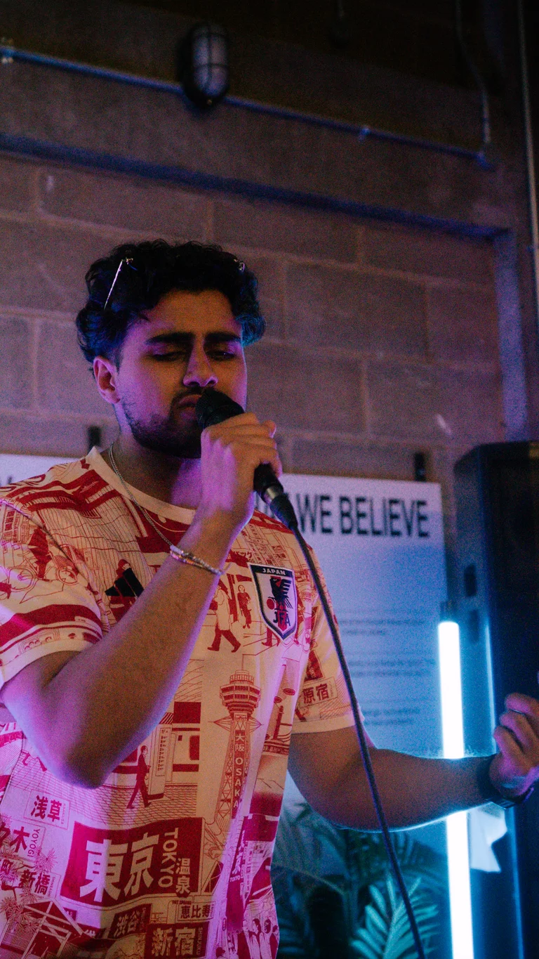 a musician performs into a mic