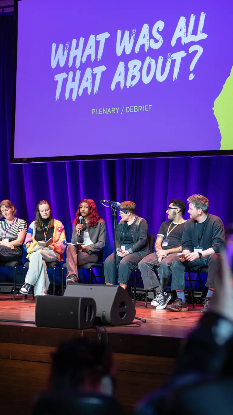 a panel of people on stage