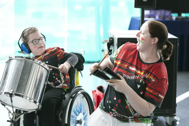 Two people from the project Jack Drum arts playing drums. 