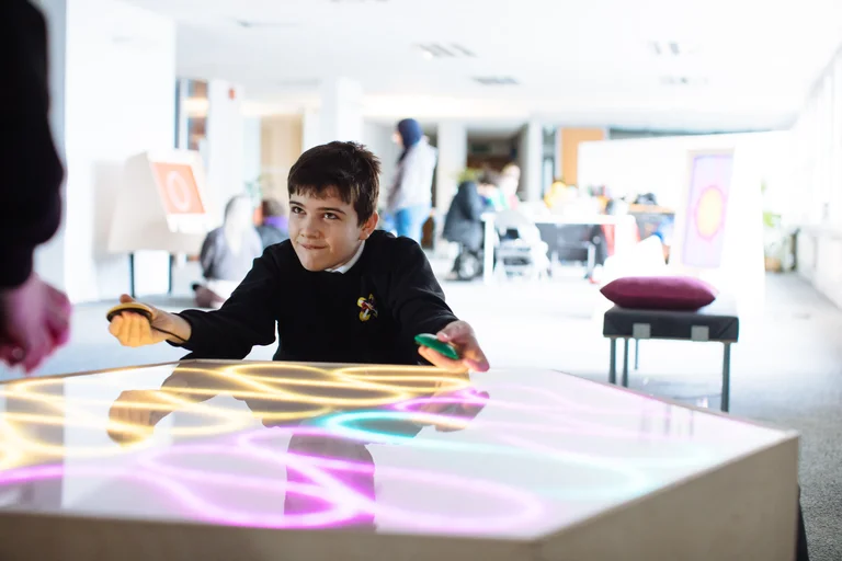 Image of a young boy interacting with a multisensory table