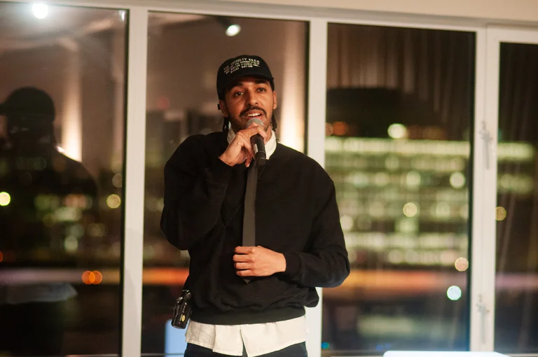 simon a sings into a microphone on stage