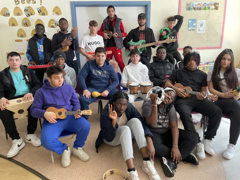 Image of young people in a music project posing for the camera