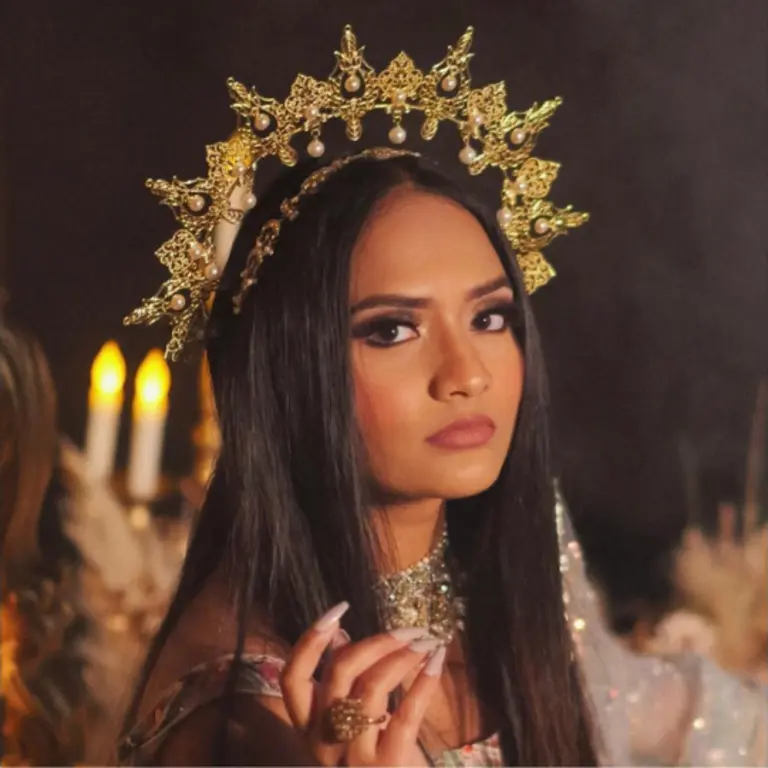 saloni looking to her right at the camera wearing a crown 