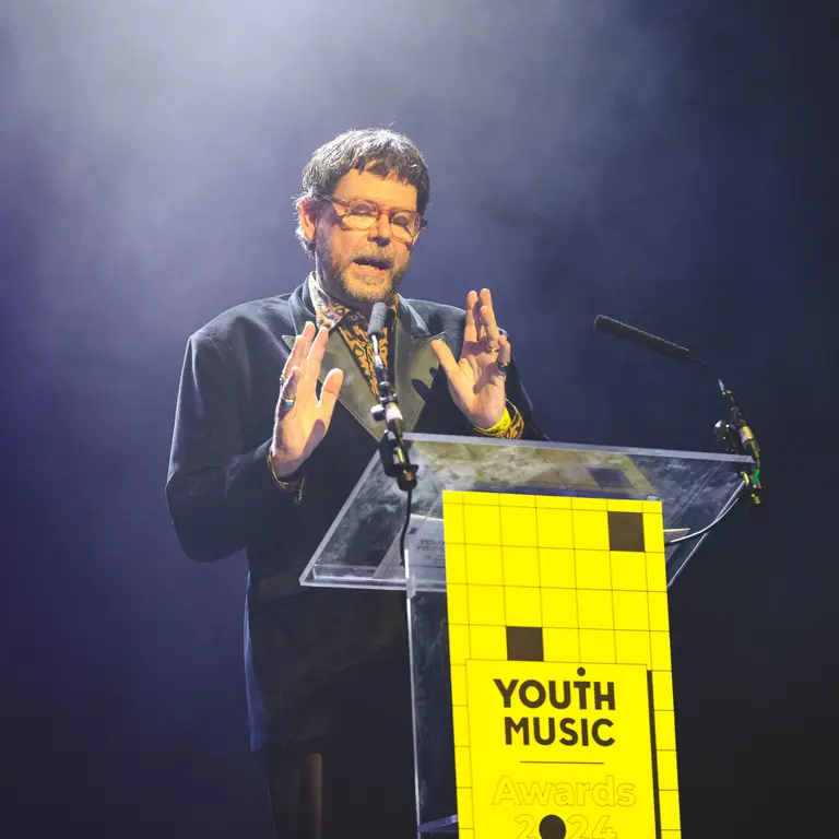 Matt Griffiths on stage at the Youth Music Awards speaking at a lectern