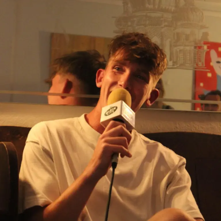 Jed Wright headshot with microphone in hand