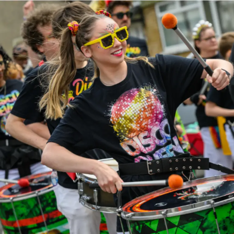 drummers smiling wearing yellow rimmed sunglasses 